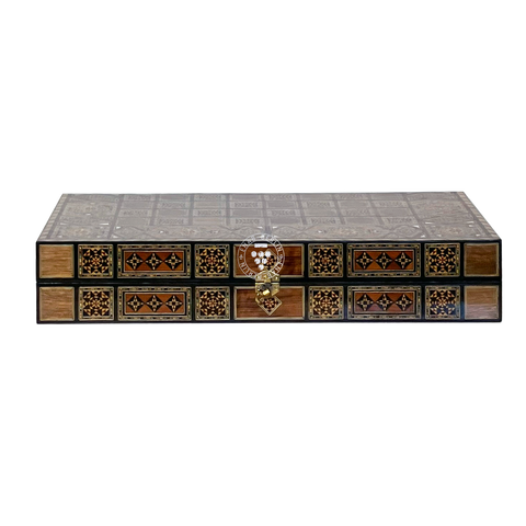 Close-up detail of the wood and mother-of-pearl mosaic inlay on the Silk Road backgammon board